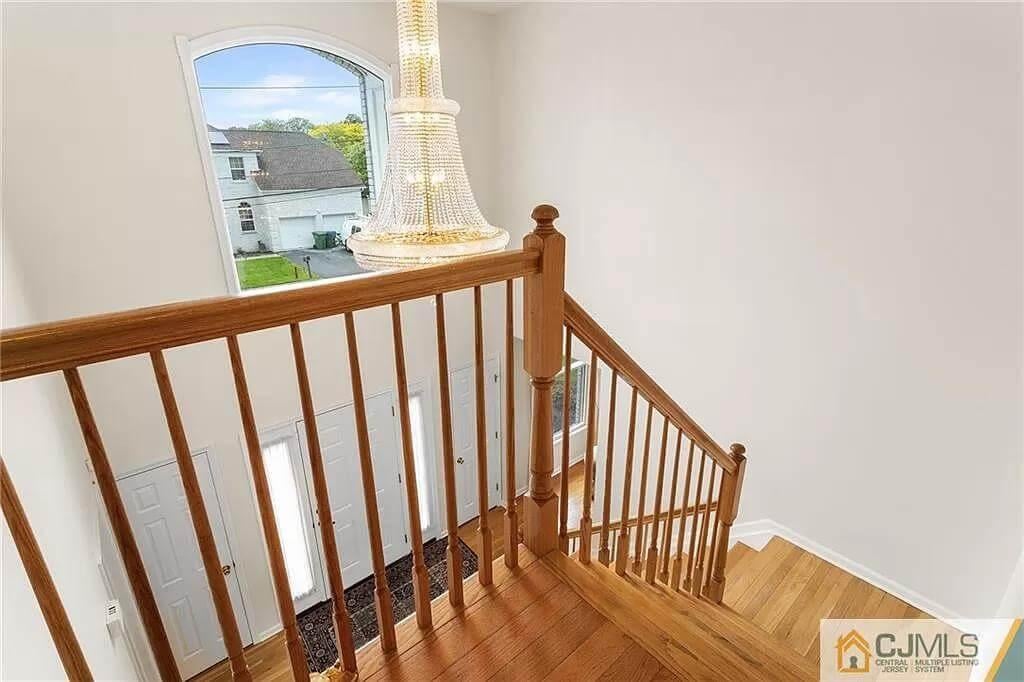 Natural Wood Staircase with a Sparkling Chandelier