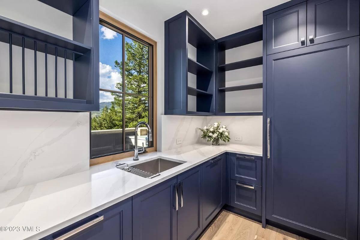 Check Out Those Bold Blue Cabinets in This Stylish Laundry Room