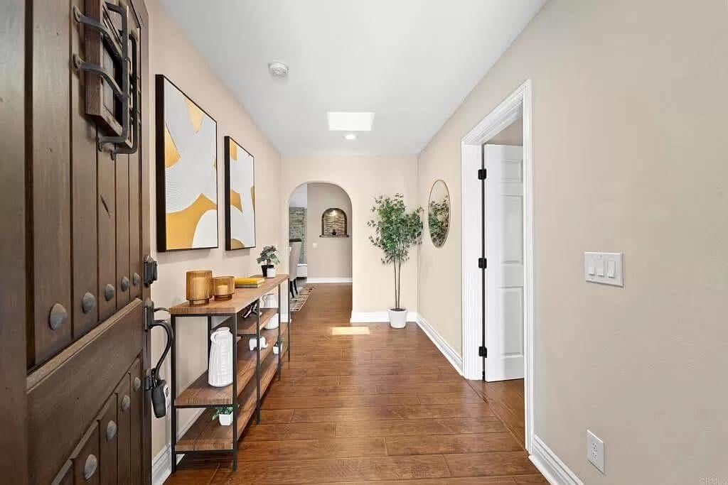 Notice the Blend of Modern Art with Warm Woods in This Hallway