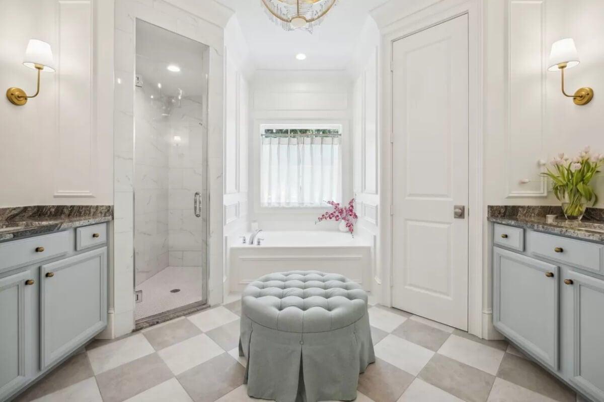 Elegant Bathroom Sanctuary Featuring a Cozy Tufted Ottoman