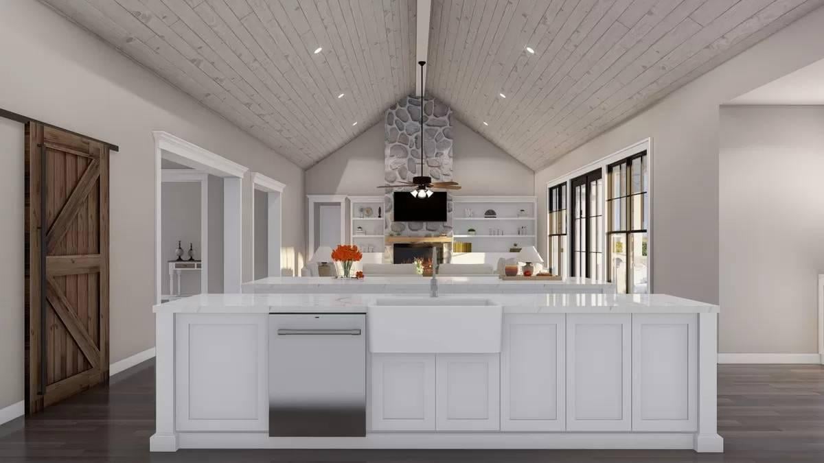 Vaulted Ceiling Kitchen with a Barn Door Touch and Stone Fireplace View