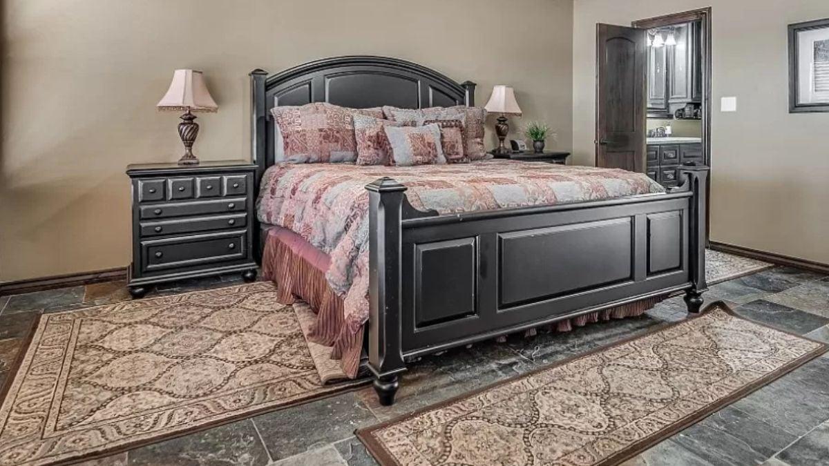 Rich Black Wood Framing a Serene Bed Setting