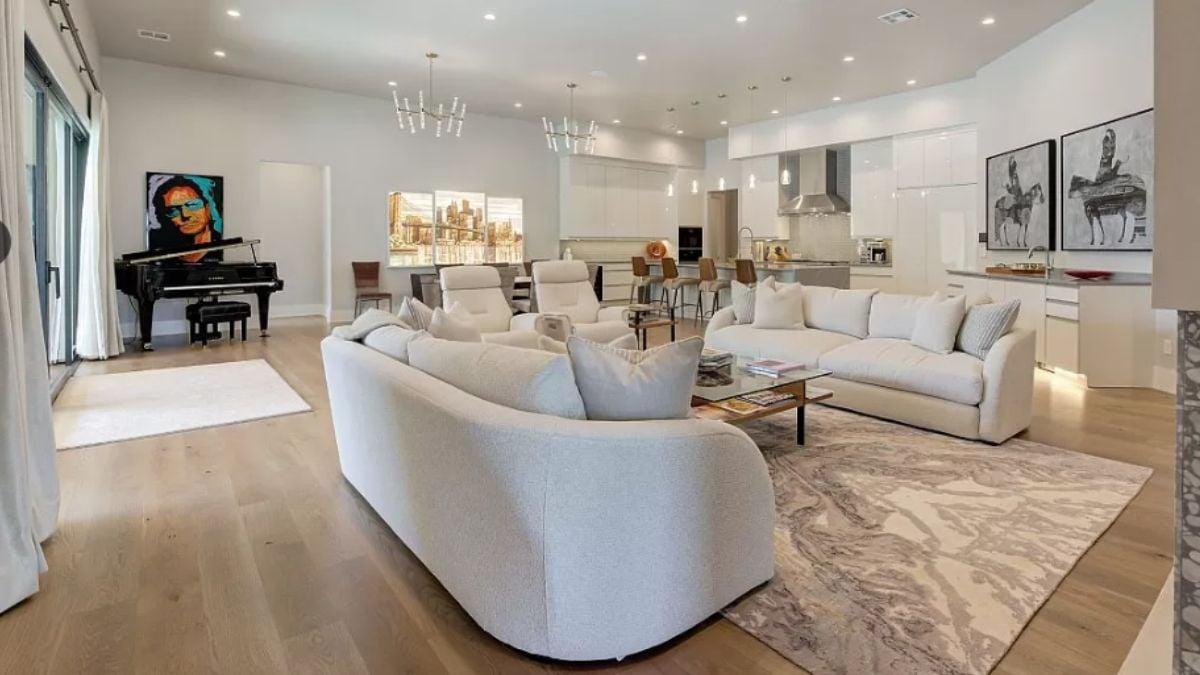 Step Into This Spacious Living Room With a Striking Art Piece and Grand Piano