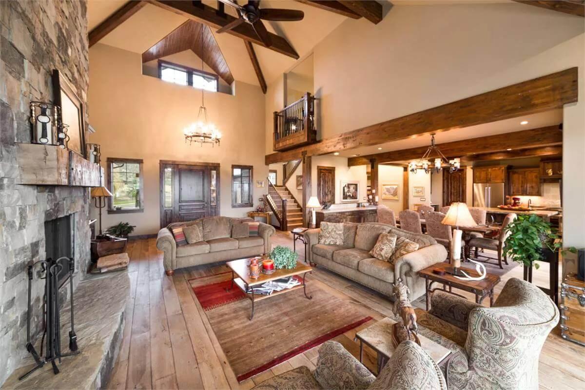 Rustic Elegance in the Great Room with Lofted Beams and Stone Hearth