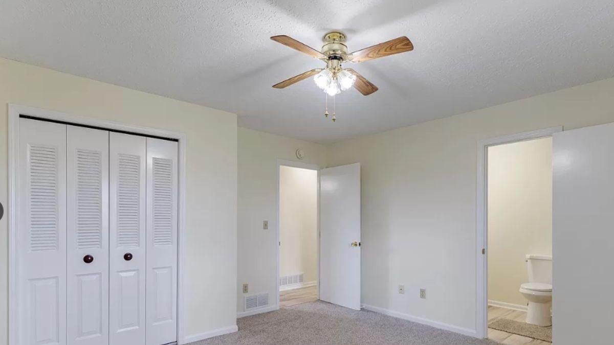 Simple Bedroom Featuring a Functional Ceiling Fan