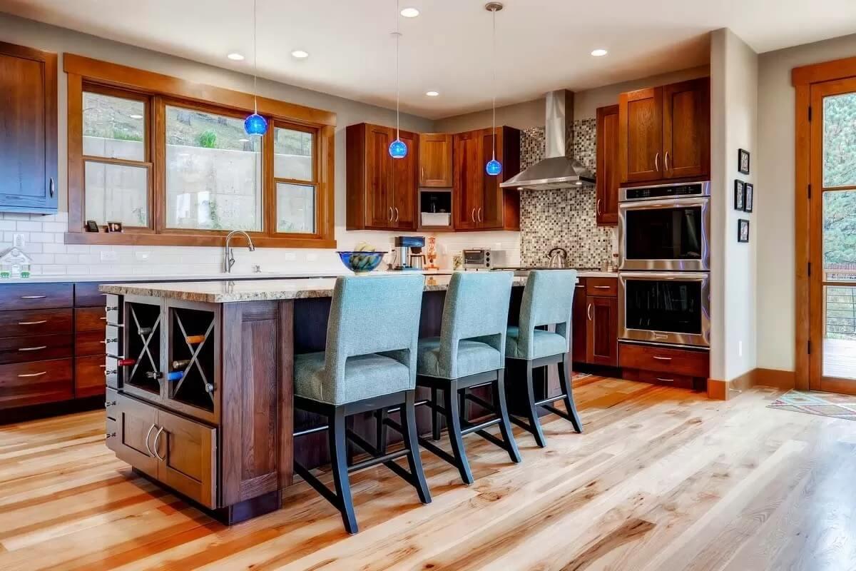 Admire the Wine Storage and Blue Accents in This Warm Kitchen