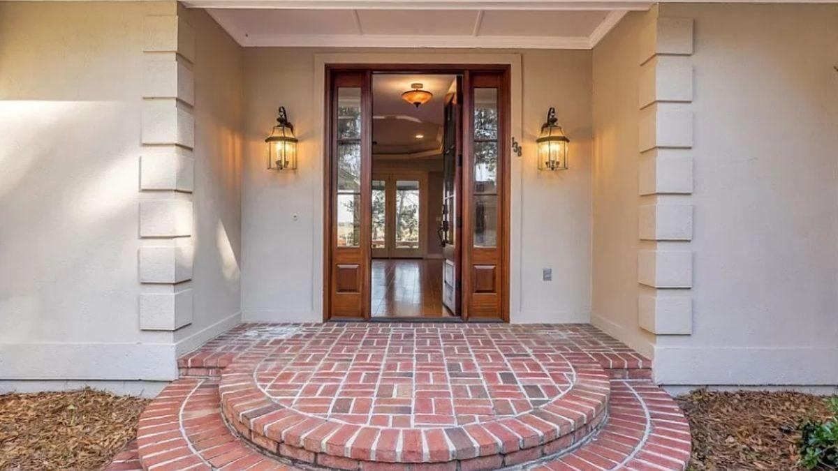 Elegant Entryway with Warm Wooden Door and Brick Steps