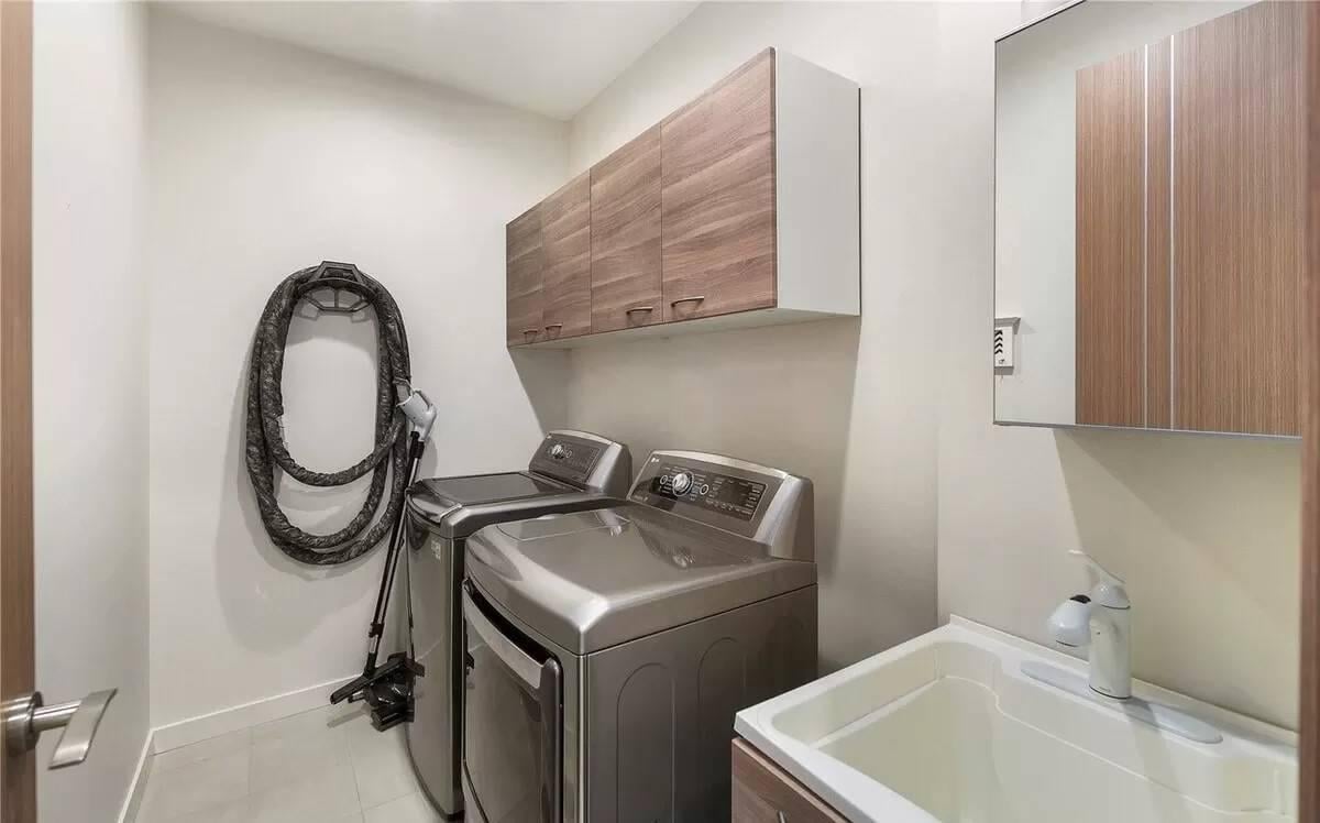 Functional Laundry Room With Wood Accented Cabinetry