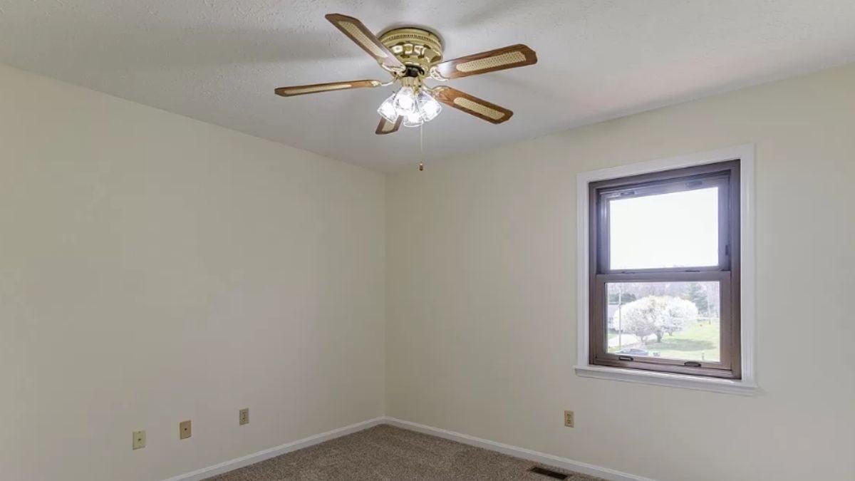 Minimalist Bedroom with Functional Fan and Natural Light