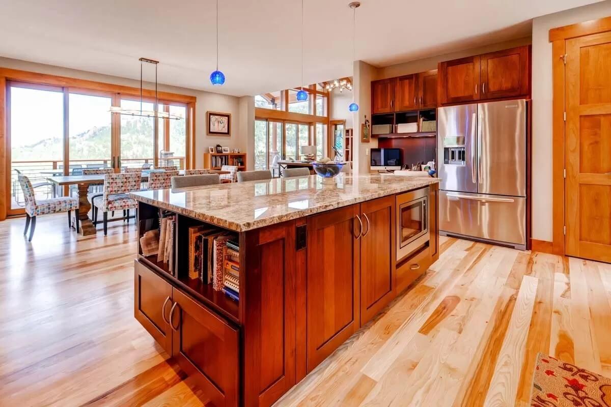 Admire the Expansive Island and Warm Wood Accents in This Open Kitchen