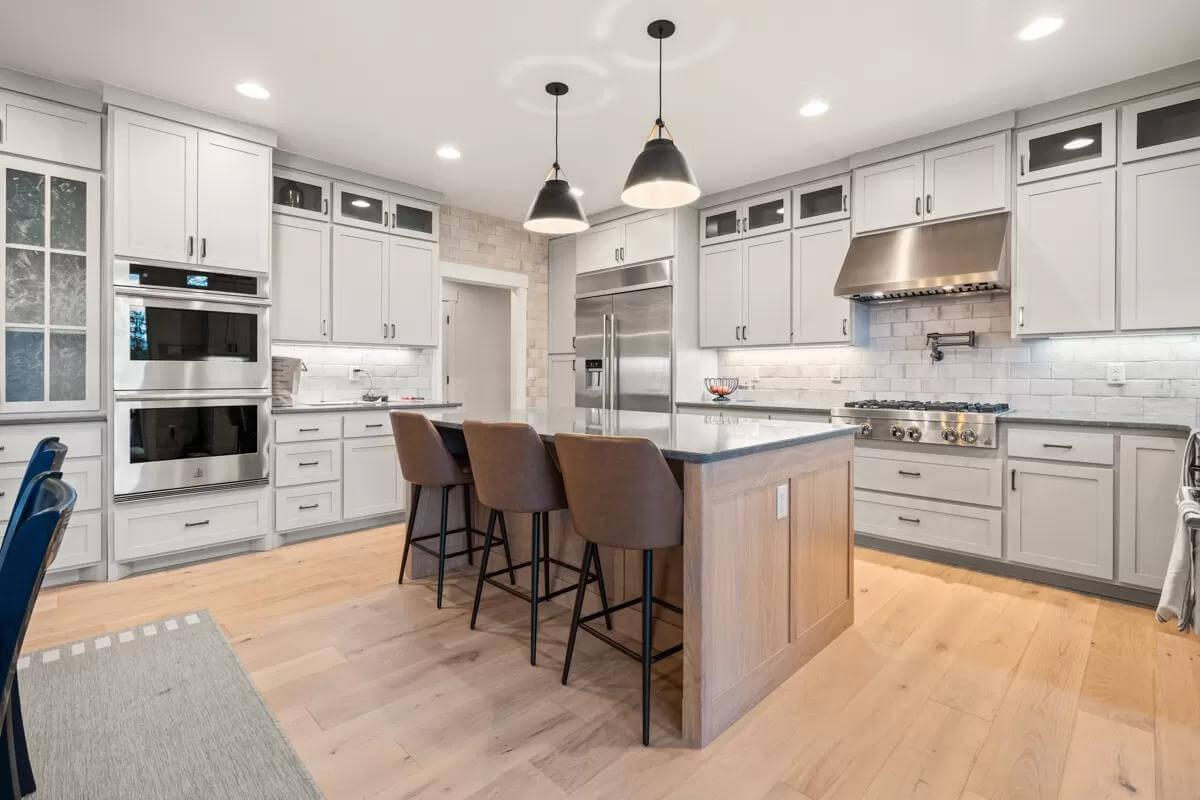 Sleek Kitchen Island Steals the Show with Contrasting Countertops
