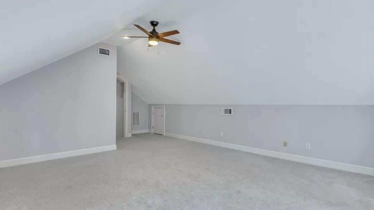 Unique Sloped Ceiling in This Bright Attic Room