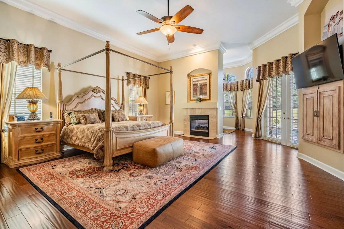 Four-Poster Bed and a Cozy Fireplace in This Elegant Bedroom