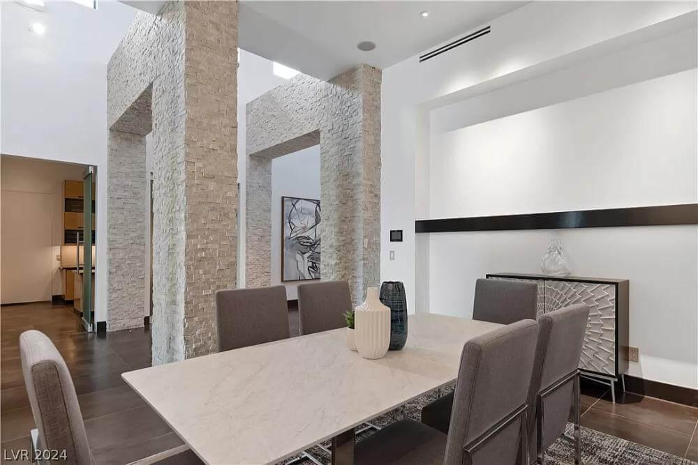 Modern Dining Space Framed by Dramatic Stone Columns