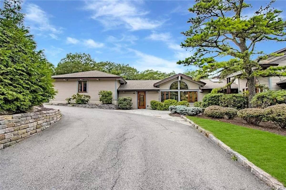 Stunning Craftsman Facade with Arched Window and Serene Landscape