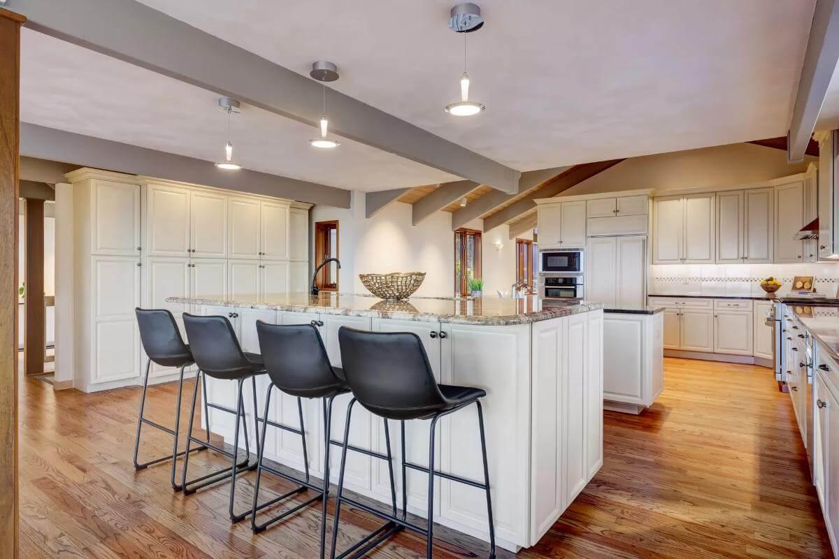 Check Out the Expansive Kitchen Island with Granite Countertops