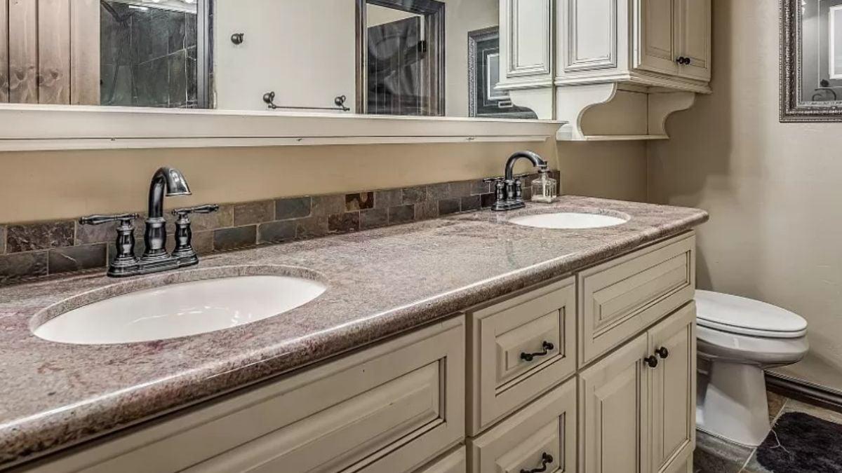 Dual Sinks with Rustic Tile and Elegant Cabinetry