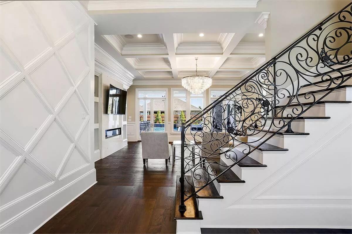 Notice How the Ornate Staircase Complements the Dramatic Coffered Ceiling