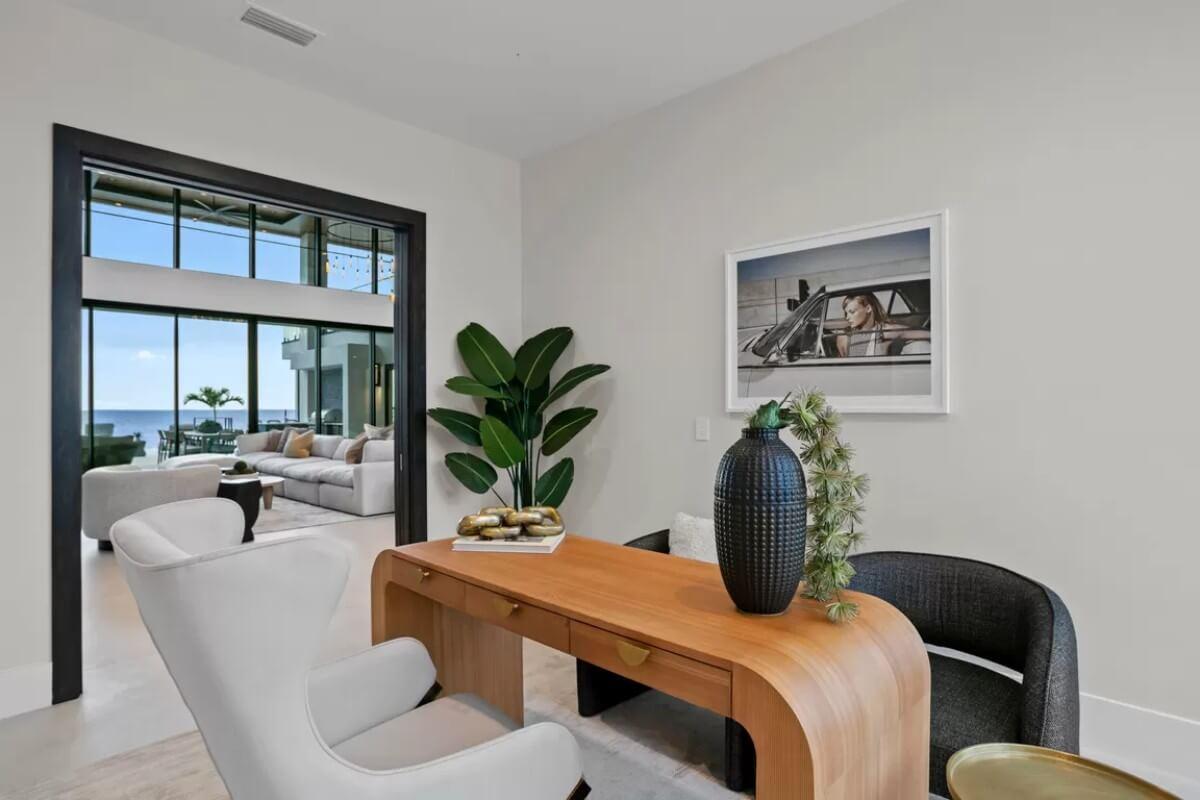 Modern Office Nook with Curved Wood Desk and Thoughtful Decor