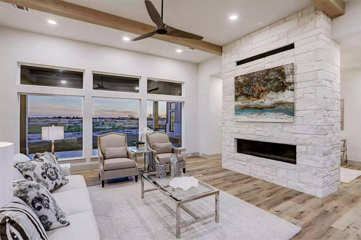Modern Living Room with Striking Stone Fireplace and Art Display