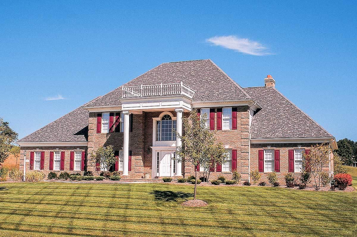 Classic Brick Facade with Striking Red Shutters and Elegant Columns