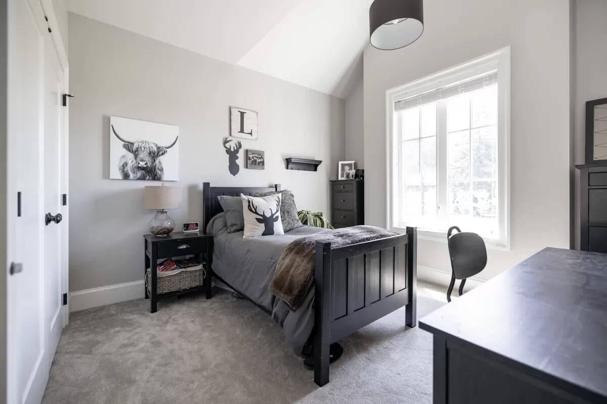 Cozy Bedroom With Antler Decor and Vaulted Ceilings