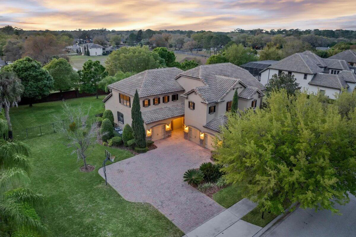 Explore This Mediterranean Home with a Spacious Brick Driveway