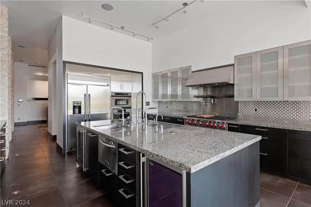 Gourmet Kitchen with Expansive Granite Island and Metal Accents