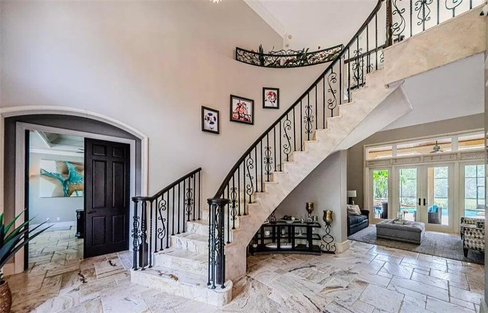 Wow, Check Out This Grand Staircase with Ornate Wrought Iron Detailing