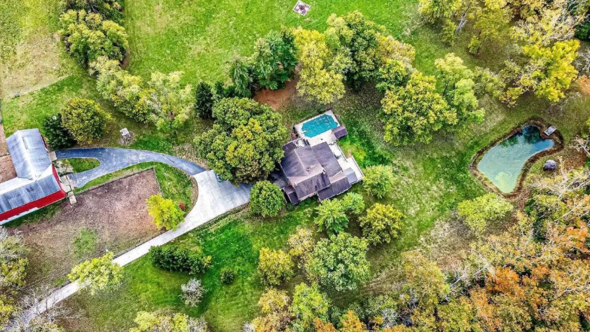 Aerial View Showcasing the Pool and Pond Amidst Autumn Hues