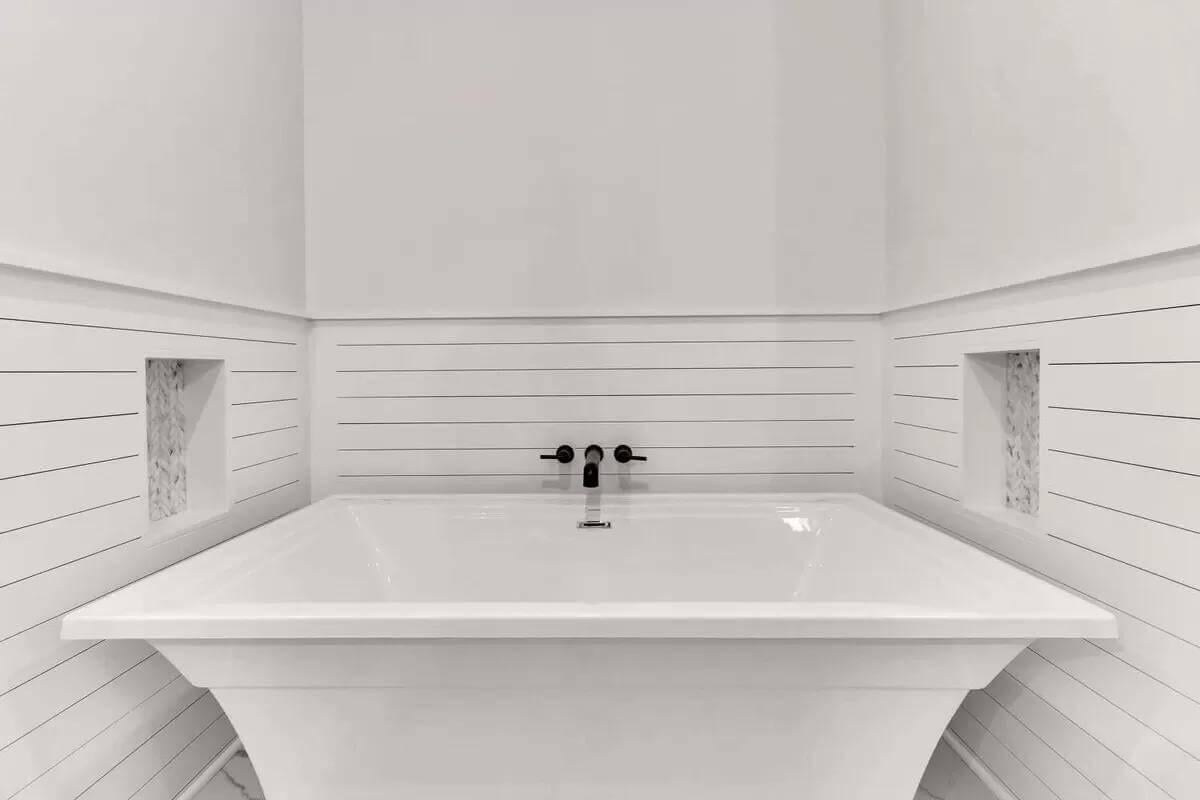 Minimalist Bathroom with a Built-In Soaking Tub and Subtle Shiplap