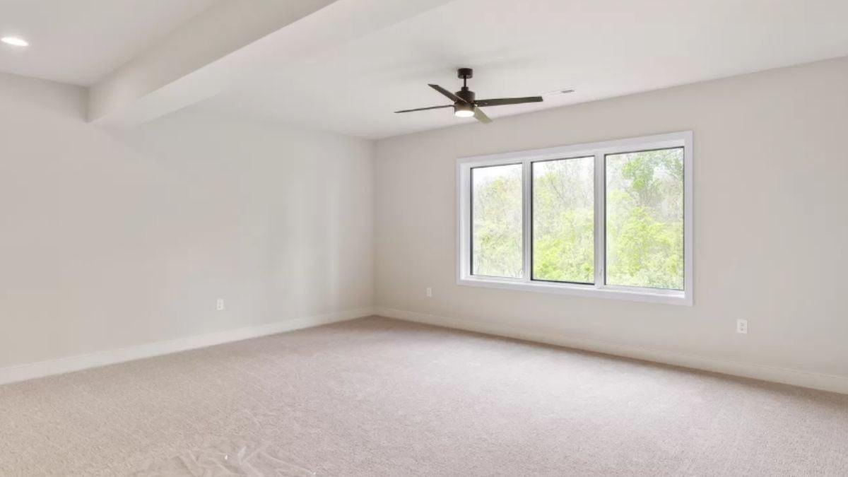 Notice the Sleek Ceiling Fan in This Spacious Minimalist Room