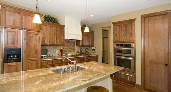 Craftsman Kitchen with Gorgeous Granite Island and Wooden Cabinetry