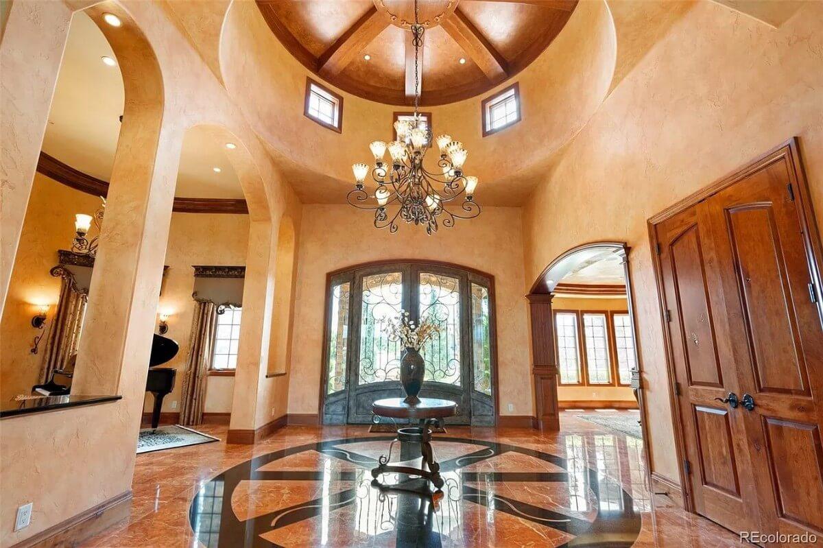 Towering Dome Ceiling With Elegant Chandelier Sets the Entrance Scene