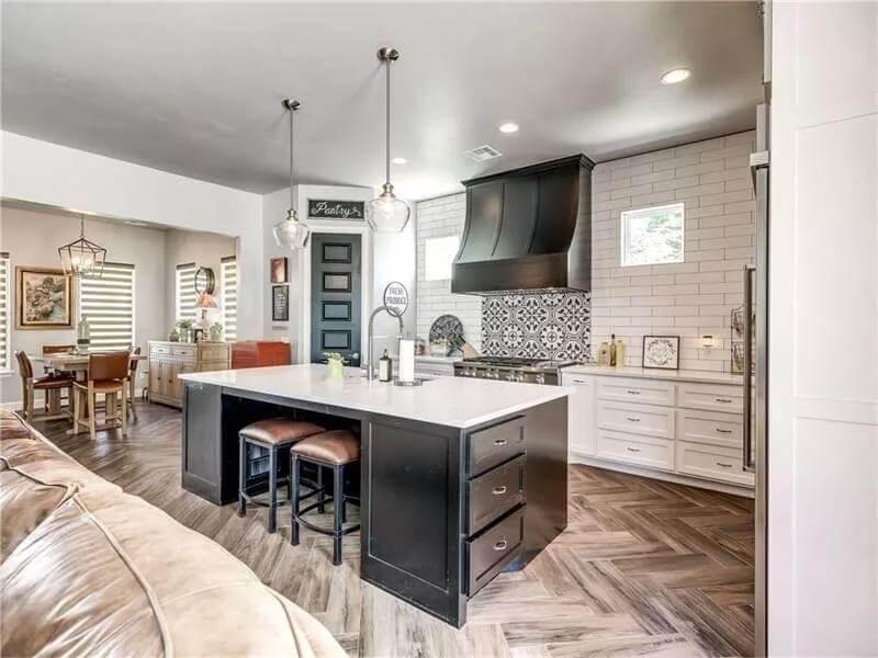 This Kitchen Features a Bold Black Hood and Intricate Backsplash