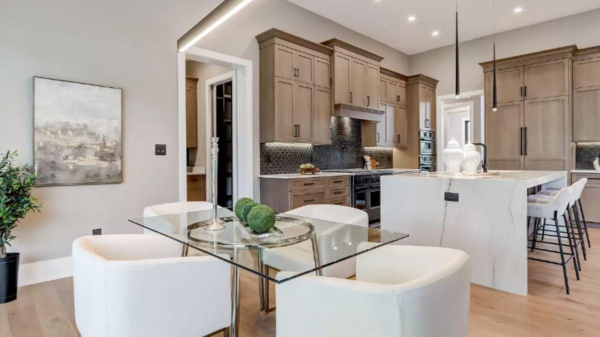 Discover the Sleek Glass Dining Table that Complements This Modern Kitchen