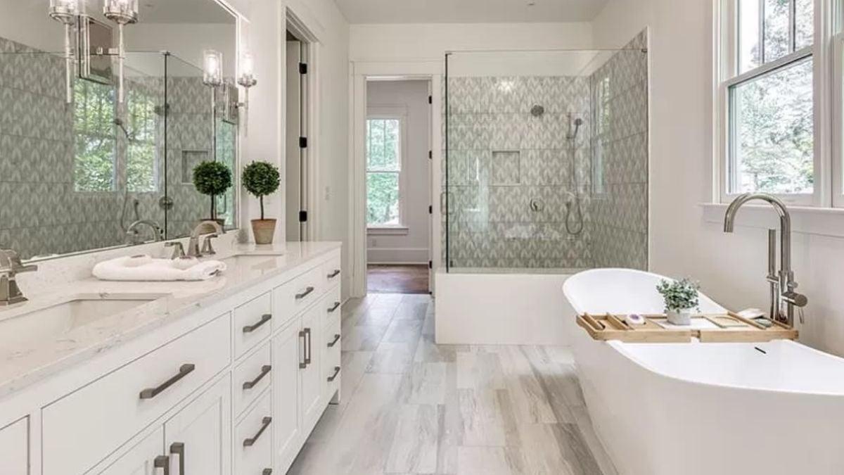 Effortlessly Elegant Bathroom with a Freestanding Tub and Patterned Shower Wall