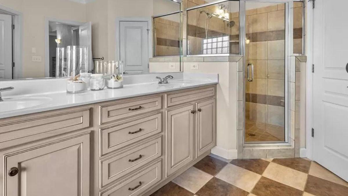 Elegant Bathroom with Neutral Cabinetry and Checkered Tile