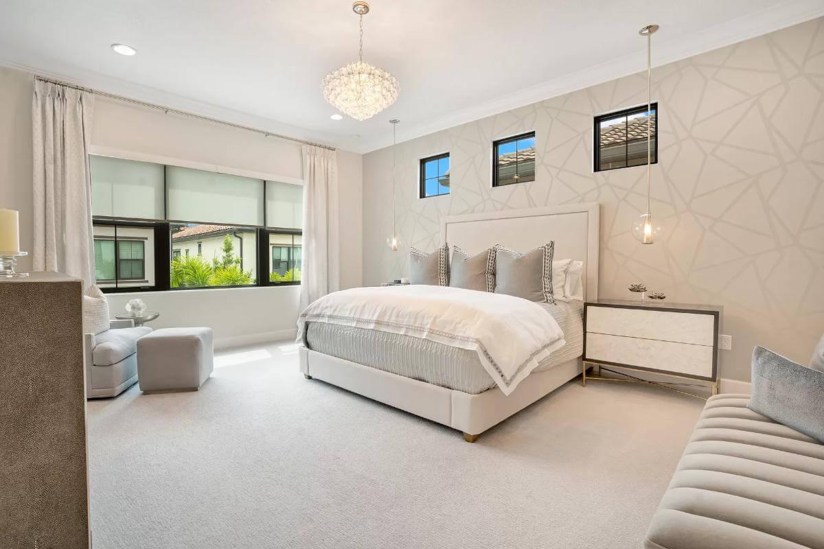 Elegant Bedroom with Chic Patterned Wallpaper and Crystal Chandelier