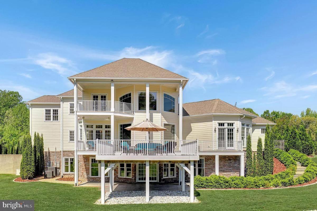 Notice the Elegant Balcony Overlooking This Spacious Backyard