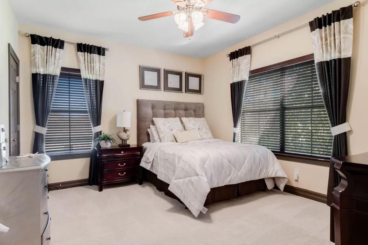Classic Bedroom Design with Plush Headboard and Elegant Drapery