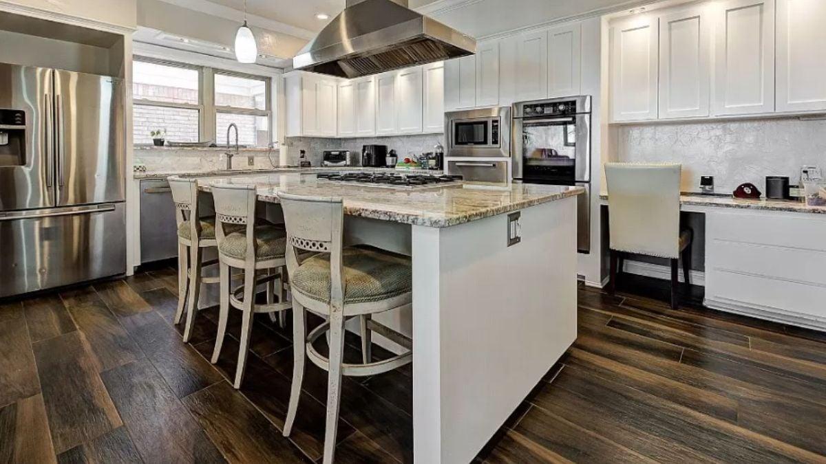 Admire the Large Island and Sleek Appliances in This Modern Kitchen