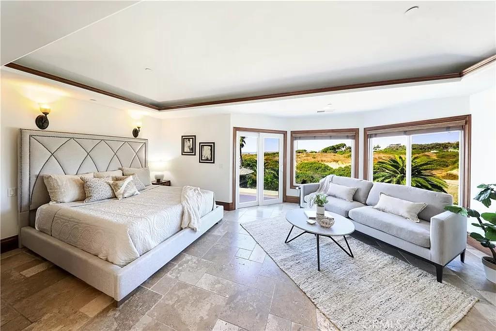 Relax in This Tranquil Bedroom with Scenic Views and a Cozy Lounge Area