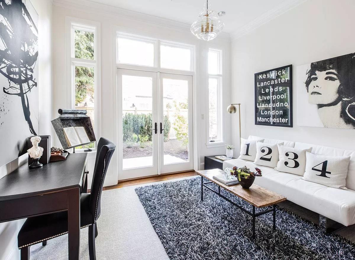 This Eclectic Home Office Offers Both Style and Substance with Bold Artwork and Dark Furniture