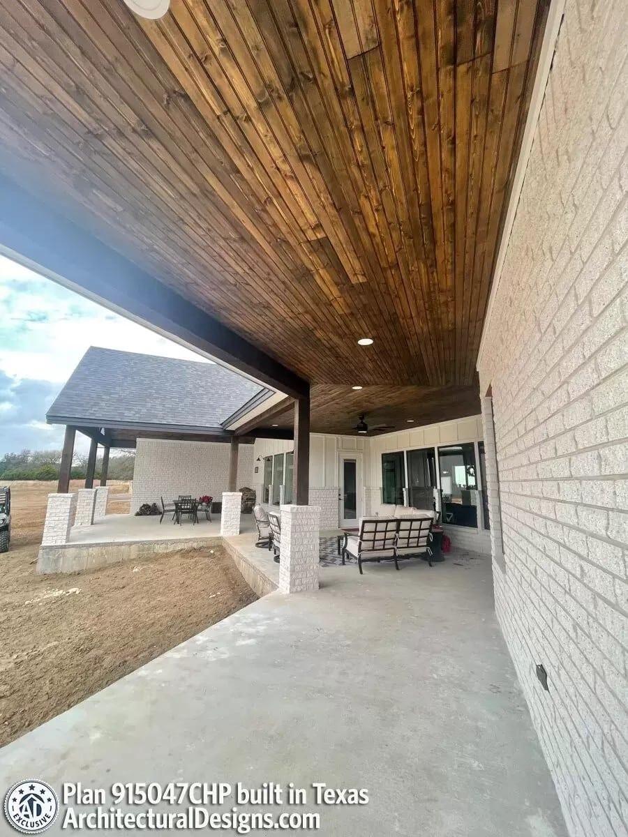 Notice the Wooden Ceiling Adding Warmth to the Expansive Porch