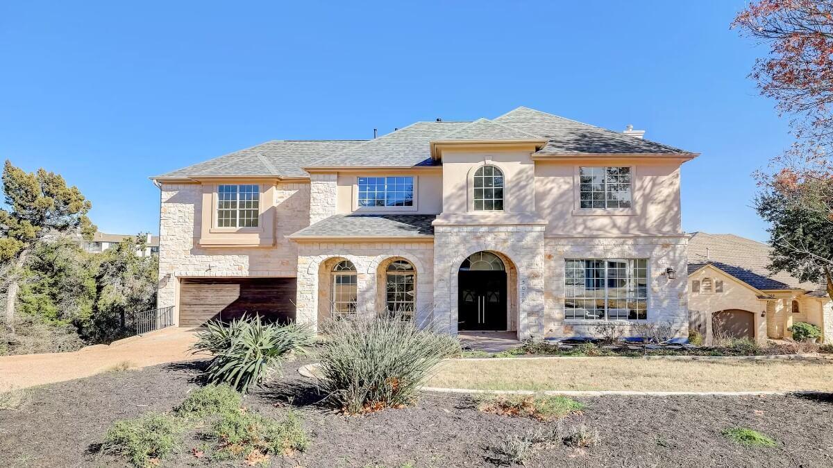 Check Out the Stunning Arched Windows on This Stone-Front Home