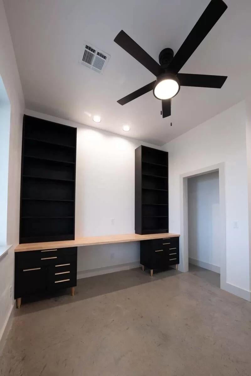 Sleek Workspace with Black Built-Ins and a Minimalist Ceiling Fan