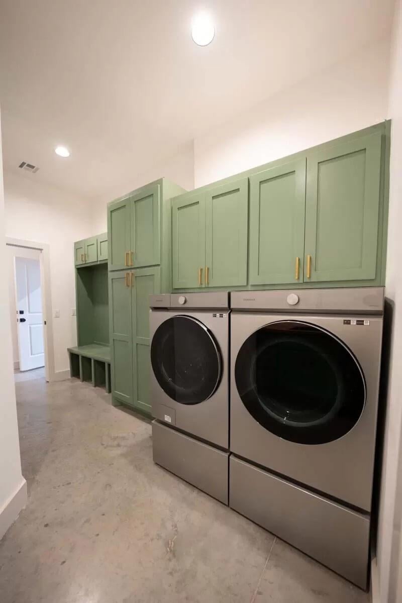 Check Out This Laundry Room with Sage Green Cabinets and Sleek Appliances