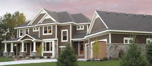 Traditional Craftsman Exterior with Stone Detailing and Elegant Rooflines