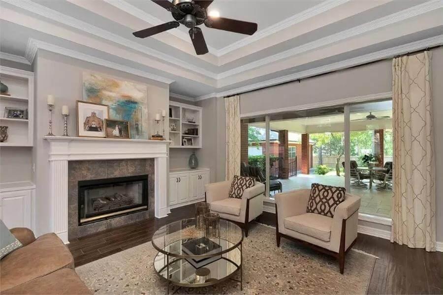 Spacious Living Room With a Tray Ceiling and Fireplace Focal Point